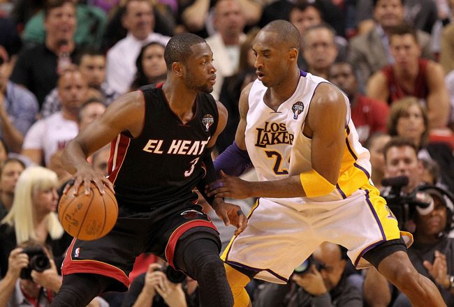 MIAMI, FL - MARCH 10:  Dwyane Wade #3 of the Miami Heat posts up Kobe Bryant #24 of the Los Angeles Lakers during a game at American Airlines Arena on March 10, 2011 in Miami, Florida. NOTE TO USER: User expressly acknowledges and agrees that, by download