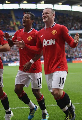 BOLTON, ENGLAND - SEPTEMBER 10: Wayne Rooney (R) of Manchester United celebrates scoring his sides third goal alongside Nani (L) during the Barclays Premier League at the Reebok Stadium on September 10, 2011 in Bolton, England.  (Photo by Michael Steele/G