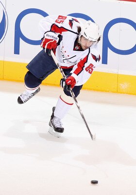 GLENDALE, AZ - FEBRUARY 14:  Mathieu Perreault #85 of the Washington Capitals passes the puck during the NHL game against the Phoenix Coyotes at Jobing.com Arena on February 14, 2011 in Glendale, Arizona.  The Coyotes defeated the Capitals 3-2.  (Photo by