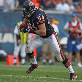 CHICAGO, IL - SEPTEMBER 11: Brian Urlacher #54 of the Chicago Bears runs for a touchdown after picking up a fumbled ball against the Atlanta Falcons at Soldier Field on September 11, 2011 in Chicago, Illinois. The Bears defeated the Falcons 30-12. (Photo