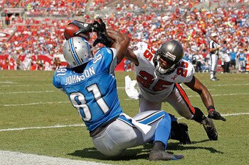 TAMPA, FL - SEPTEMBER 11:  Calvin Johnson #81 of the Detroit Lions makes a touchdown catch over  Aqib Talib #25 of the Tampa Bay Buccaneers during the season opener at Raymond James Stadium on September 11, 2011 in Tampa, Florida.  (Photo by Mike Ehrmann/