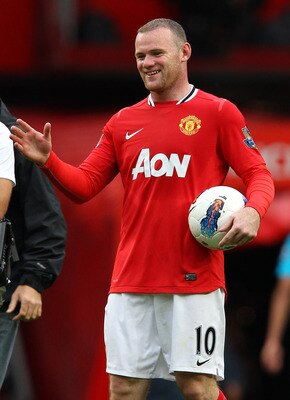 MANCHESTER, ENGLAND - AUGUST 28:  Wayne Rooney of Manchester United carries the match ball after scoring a hat trick in the Barclays Premier League match between Manchester United and Arsenal at Old Trafford on August 28, 2011 in Manchester, England.  (Ph