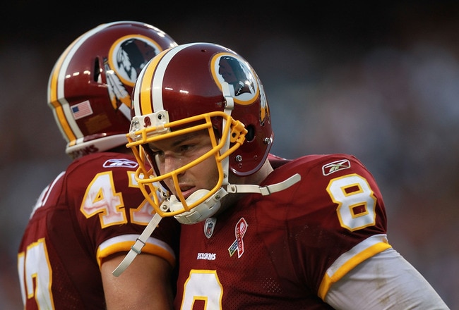 LANDOVER, MD - SEPTEMBER 11:  Rex Grossman celebrates a touchdown with  Chris Cooley #47 of the Washington Redskins against the New York Giants during the season opener at FedExField on September 11, 2011 in Landover, Maryland.  (Photo by Ronald Martinez/