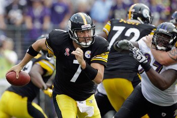 BALTIMORE, MD - SEPTEMBER 11: Quarterback  Ben Roethlisberger #7 of the Pittsburgh Steelers scrambles while being pressured by defender Arthur Jones #97 of the Baltimore Ravens during second half of the season opener at M&T Bank Stadium on September 11, 2