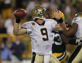GREEN BAY, WI - SEPTEMBER 08:  Drew Brees #9 of the New Orleans Saints throws a pass against the Green Bay Packers during the NFL opening season game at Lambeau Field on September 8, 2011 in Green Bay, Wisconsin. The Packers defeated the Saints 42-34.  (P