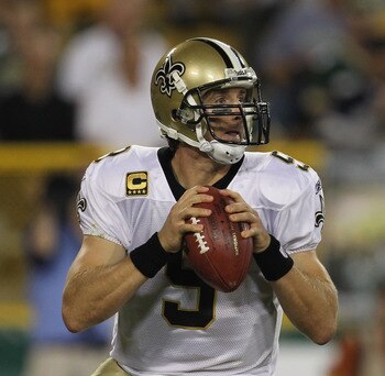 GREEN BAY, WI - SEPTEMBER 08:Drew Brees #9 of the New Orleans Saints looks for a receiver against the Green Bay Packers during the NFL opening season game at Lambeau Field on September 8, 2011 in Green Bay, Wisconsin. The Packers defeated the Saints 42-34