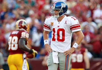 LANDOVER, MD - SEPTEMBER 11:   Eli Manning #10 of the New York Giants walks off the field during the season opener against the Washington Redskins at FedExField on September 11, 2011 in Landover, Maryland.  (Photo by Ronald Martinez/Getty Images)