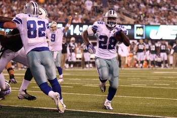 EAST RUTHERFORD, NJ - SEPTEMBER 11:  Felix Jones #28 of the Dallas Cowboys scores a 1-yard touchdown run in the fourth quarter against the New York Jets during their NFL Season Opening Game at MetLife Stadium on September 11, 2011 in East Rutherford, New