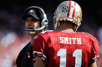 SAN FRANCISCO, CA - SEPTEMBER 11: Head coach Jim Harbaugh of the San Francisco 49ers talks with his quarterback Alex Smith #11 the while there's a timeout against the Seattle Seahawks in the third quarter of the season-opening game at Candlestick Park on