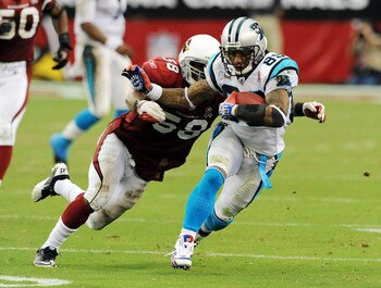 GLENDALE, AZ - SEPTEMBER 11:  Steve Smith #89 of the Carolina Panthers runs away from Daryl Washington #58 of the Arizona Cardinals in the NFL season opening game at the University of Phoenix Stadium on September 11, 2011 in Glendale, Arizona. Arizona won