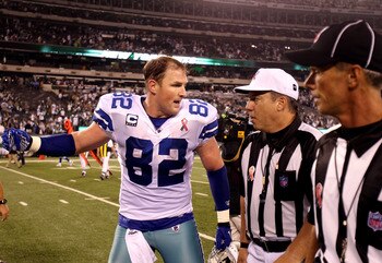 EAST RUTHERFORD, NJ - SEPTEMBER 11:  Jason Witten #82 of the Dallas Cowboys arguees with referee Al Riveron #57 as they walk offsides the field after the New York Jets won 27-24 during their NFL Season Opening Game at MetLife Stadium on September 11, 2011