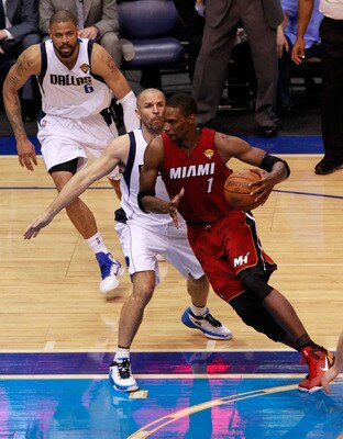 DALLAS, TX - JUNE 07:  Chris Bosh #1 of the Miami Heat drives against Jason Kidd #2 and Tyson Chandler #6 of the Dallas Mavericks in Game Four of the 2011 NBA Finals at American Airlines Center on June 7, 2011 in Dallas, Texas. The Mavericks won 86-83. NO