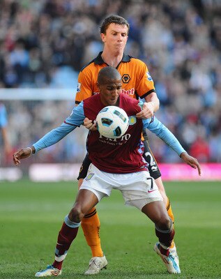 BIRMINGHAM, ENGLAND - MARCH 19:  Ashley Young of Aston Villa is challenged by Kevin Foley of Wolves during the Barclays Premier League match between Aston Villa and Wolverhampton Wanderers at Villa Park on March 19, 2011 in Birmingham, England.  (Photo by