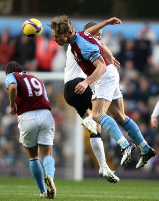 BIRMINGHAM, UNITED KINGDOM - NOVEMBER 29:  Bobby Zamora of Fulham is challenged by Martin Laursen of Aston Villa during the Barclays Premier League match between Aston Villa and Fulham at Villa Park on  November 29, 2008 in Birmingham, England.  (Photo by