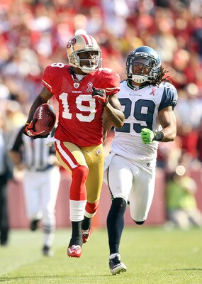 SAN FRANCISCO, CA - SEPTEMBER 11:  Ted Ginn #19 of the San Francisco 49ers outruns Earl Thomas #29 of the Seattle Seahawks on his way to scoring a touchdown on a kickoff return during their season opener at Candlestick Park on September 11, 2011 in San Fr