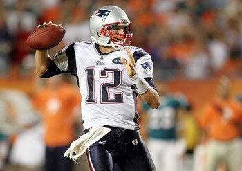 MIAMI GARDENS, FL - SEPTEMBER 12: Quarterback Tom Brady #12 of the New England Patriots throws against the Miami Dolphins at Sun Life Stadium on September 12, 2011 in Miami Gardens, Florida.  (Photo by Marc Serota/Getty Images)