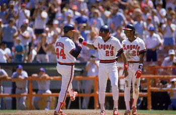 ANAHEIM, CA - SEPTEMBER 15:  Reggie Jackson #44 of the California Angels is congratulated after his home run by teammates Rod Carew #29 and Gary Pettis #20 during a MLB game against the Texas Rangers at Angel Stadium on September 15, 1985 in Anaheim, Cali