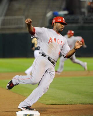 OAKLAND, CA - SEPTEMBER 12: Torii Hunter #48 of the Los Angeles Angels of Anaheim rounds third base scoring on a Vernon Wells triple against the Oakland Athletics in the second inning during an MLB baseball game at O.co Coliseum on September 12, 2011 in O