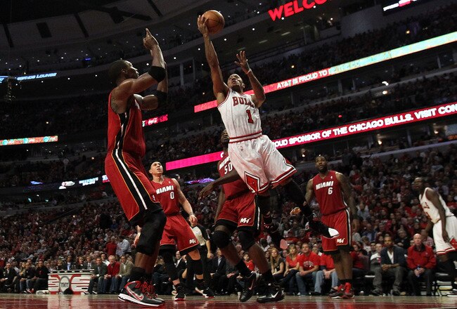 CHICAGO, IL - MAY 26:  Derrick Rose #1 of the Chicago Bulls drives for a shot attempt against Chris Bosh #1 of the Miami Heat in Game Five of the Eastern Conference Finals during the 2011 NBA Playoffs on May 26, 2011 at the United Center in Chicago, Illin