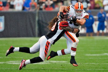 CLEVELAND, OH - SEPTEMBER 11: Linebacker Rey Maualuga #58 of the Cincinnati Bengals tackles Peyton Hillis #40 of the Cleveland Browns during the fourth quarter at Cleveland Browns Stadium during a season opener  on September 11, 2011 in Cleveland, Ohio. T