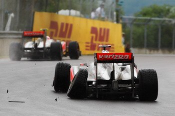 MONTREAL, CANADA - JUNE 12:  Lewis Hamilton of Great Britain and McLaren suffers damage to his rear left wheel after driving too close to team mate Jenson Button of Great Britain and McLaren in the early stage of the Canadian Formula One Grand Prix at the