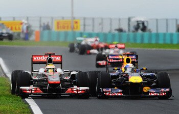 BUDAPEST, HUNGARY - JULY 31:  (L-R) Lewis Hamilton of Great Britain and McLaren and Sebastian Vettel of Germany and Red Bull Racing race side by side during the Hungarian Formula One Grand Prix at the Hungaroring on July 31, 2011 in Budapest, Hungary.  (P