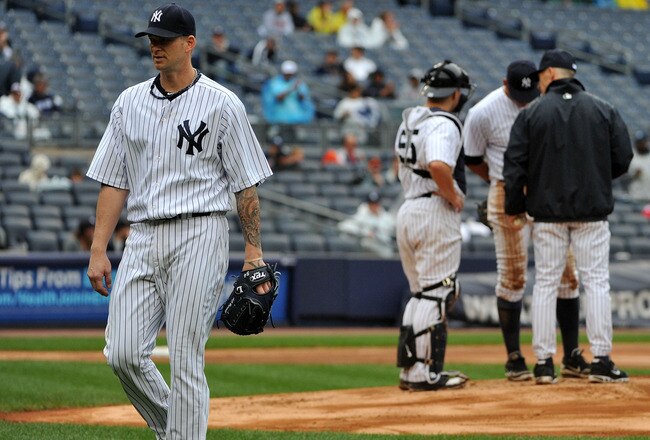 NEW YORK, NY - SEPTEMBER 07: A.J. Burnett #34 of the New York Yankees walks back to the dugout after being taken out of the game in the top of the seventh inning against the Baltimore Orioles and New York Yankees on September 7, 2011 at Yankee Stadium in
