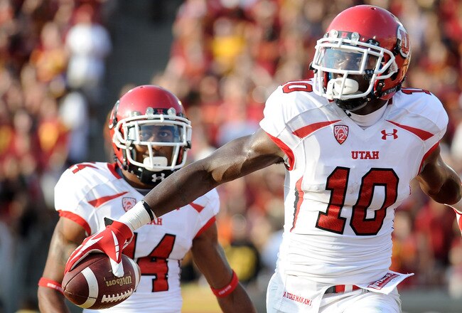 LOS ANGELES, CA - SEPTEMBER 10:  DeVonte Christopher #10 of the Utah Utes celebrates his touchdown with Reggie Dunn #14 to trail 10-7 turnover the USC Trojans during the second quarter at Los Angeles Memorial Coliseum on September 10, 2011 in Los Angeles,