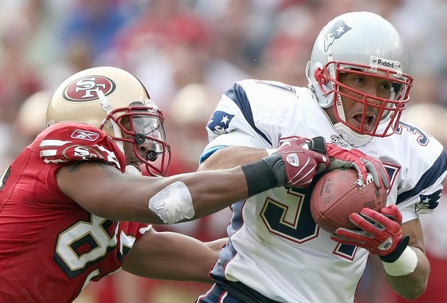 SAN FRANCISCO - OCTOBER 5:  Rodney Harrison #37 of the New England Patriots grips the ball as he is grabbed by Arnaz Battle #83 of the San Francisco 49ers during an NFL game on October 5, 2008 at Monster Park in San Francisco, California.