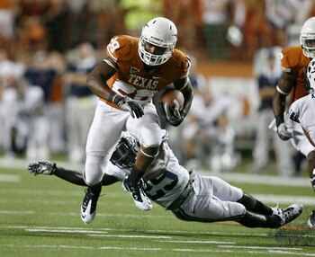 AUSTIN, TX - SEPTEMBER 10:  Running back Malcolm Brown #28 of the Texas Longhorns gets past defensive back Skye PoVey #29 of the BYU Cougars on September 10, 2011 at Darrell K. Royal-Texas Memorial Stadium in Austin, Texas.  Texas defeated BYU 17-16.  (Ph