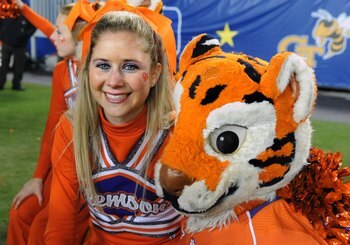 TAMPA, FL - NOVEMBER 28: A cheerleader of the Clemson Tigers poses with the team mascot on the sidelines against the Georgia Tech Yellow Jackets in the 2009 ACC Football Championship Game December 5, 2009 at Raymond James Stadium in Tampa, Florida.  (Phot