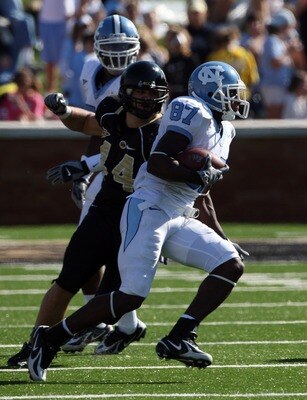 WINSTON SALEM, NC - OCTOBER 27:  Mike Rinfrette #44 the Linebacker of Wake Forest Demon Deacons tackles Brandon Tate #87 of the UNC Tar Heels during the ACC game at the Groves Stadium, on October 27, 2007 in Winston Salem,North Carolina.  (Photo by David