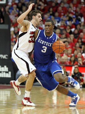 LOUISVILLE, KY - DECEMBER 31:  Terrence Jones #3 of the Kentucky Wildcats  dribbles the ball while defended by Mike Marra #33 of the Louisville Cardinals during the game at the KFC Yum! Center on December 31, 2010 in Louisville, Kentucky. Kentucky won 78-