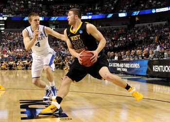 TAMPA, FL - MARCH 19:  Dalton Pepper #32 of the West Virginia Mountaineers drives against Jon Hood #4 of the Kentucky Wildcats uring the third round of the 2011 NCAA men's basketball tournament at St. Pete Times Forum on March 19, 2011 in Tampa, Florida.