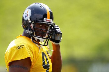 LATROBE, PA - JULY 29:  James Harrison #92 of the Pittsburgh Steelers snaps in his chin guard during training camp on July 29, 2011 at St Vincent College in Latrobe, Pennsylvania.  (Photo by Jared Wickerham/Getty Images)
