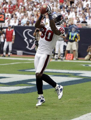 HOUSTON - SEPTEMBER 11:  Wide receiver Andre Johnson #80 of the Houston Texans completes a pass for  a touchdown in the second quarter against the Indianapolis Colts during the season opener at Reliant Stadium on September 11, 2011 in Houston, Texas.  (Ph