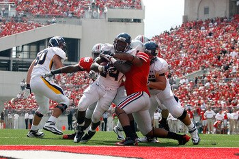COLUMBUS, OH - SEPTEMBER 10:  Adonis Thomas #24 of the Toledo Rockets powers through the Ohio State Buckeyes defense to score during the third quarter on September 10, 2011 at Ohio Stadium in Columbus, Ohio. Ohio State defeated Toledo 27-22. (Photo by Kir