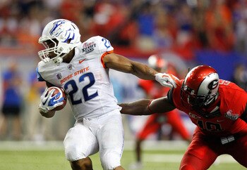 ATLANTA, GA - SEPTEMBER 03:  Doug Martin #22 of the Boise State Broncos spins away from Sanders Commings #19 of the Georgia Bulldogs at Georgia Dome on September 3, 2011 in Atlanta, Georgia.  (Photo by Kevin C. Cox/Getty Images)