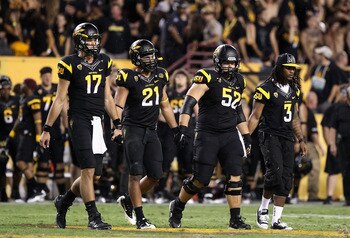 TEMPE, AZ - SEPTEMBER 09:  (L-R) Brock Osweiler #17, Colin Parker #21, Garth Gerhart #52 and Omar Bolden #3 of the Arizona State Sun Devils walk out to the overtime coin toss together during the college football game against the Missouri Tigers at Sun Dev