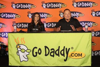SCOTTSDALE, AZ - AUGUST 25:  Danica Patrick (L) and Go Daddy CEO Bob Parsons speak at a press conference to announce her full transition to NASCAR at the GoDaddy.com Headquarters on August 25, 2011 in Scottsdale, Arizona.  (Photo by Christian Petersen/Get