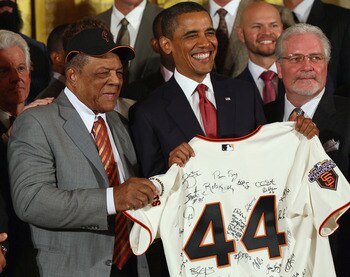 WASHINGTON, DC - JULY 25:  U.S. President Barack Obama (C) receives a jersey from Hall of Fame player Willie Mays (L) and San Francisco Giants General Manager Brian Sabean (R) during an event with the World Series champions in the East Room of the White H
