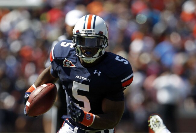 AUBURN, AL - SEPTEMBER 10:  Running back Michael Dyer #5 of the Auburn Tigers breaks for a first down run against the Mississippi State Bulldogs in the second quarter on September 10, 2011 at Jordan-Hare Stadium in Auburn, Alabama. (Photo by Butch Dill/Ge