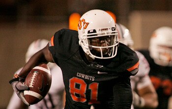 STILLWATER, OK - SEPTEMBER 8:  Wide receiver Justin Blackmon #81 of the Oklahoma State Cowboys slips past safety Mark Watley #23 of the Arizona Wildcats during the second half on September 8, 2011 at Boone Pickens Stadium in Stillwater, Oklahoma.  Oklahom