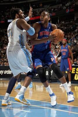 DENVER, CO - MARCH 12:  Greg Monroe #10 of the Detroit Pistons goes to the basket against Nene #31 of the Denver Nuggets at the Pepsi Center on March 12, 2011 in Denver, Colorado. The Nuggets defeated the Pistons 131-101.  NOTE TO USER: User expressly ack