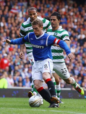 GLASGOW, SCOTLAND - SEPTEMBER 18: Steven Davis of Rangers is tackled by Beram Kayal of Celtic during the Clydesdale Bank Premier League match between Rangers and Celtic at Ibrox Stadium on September 18, 2011 in Glasgow, Scotland.   (Photo by Jeff J Mitche