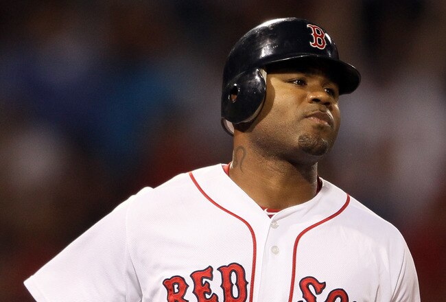 BOSTON, MA - AUGUST 30:  Carl Crawford #13 of the Boston Red Sox rounds first base after his solo home run in the fourth inning against the New York Yankees on August 30, 2011 at Fenway Park in Boston, Massachusetts.  (Photo by Elsa/Getty Images)