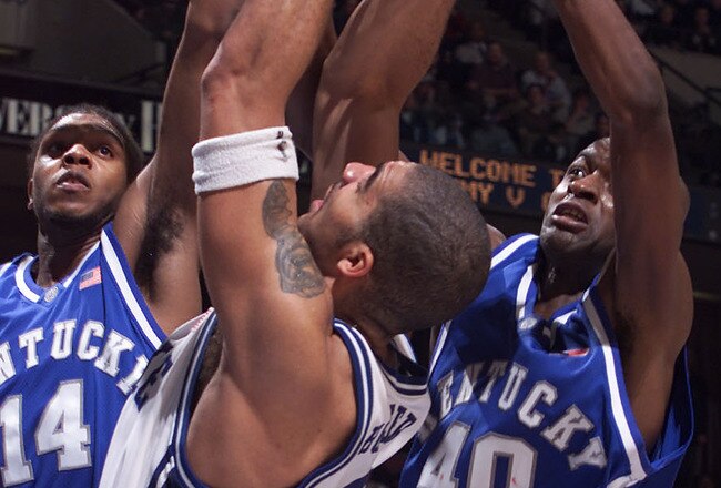 18 Dec 2001:    Carlos Boozer #4 of Duke battles S. 'Jules' Camara #40 and Erik Daniels #4 of Kentucky for a rebound during the second half of the Jimmy V Classic at Continental Airlines Arena at the Meadowlands in East Rutherford, New Jersey.  Digital Im