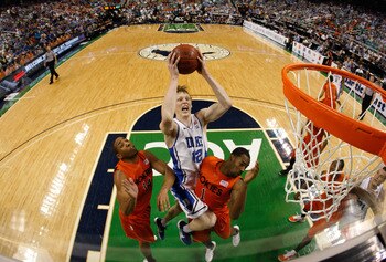 GREENSBORO, NC - MARCH 12:  Kyle Singler #12 of the Duke Blue Devils shoots against Victor Davila #14 and Terrell Bell #1 of the Virginia Tech Hokies in the semifinals of the 2011 ACC men's basketball tournament at the Greensboro Coliseum on March 12, 201