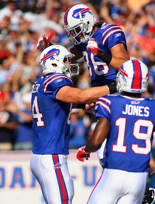 ORCHARD PARK, NY - SEPTEMBER 18:  Scott Chandler #84, David Nelson #86 and  Donald Jones #19 of the Buffalo Bills celebrate Chandler's touchdown in the fourth quarter against the Oakland Raiders at Ralph Wilson Stadium on September 18, 2011 in Orchard Par