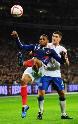 LONDON, ENGLAND - NOVEMBER 17:  Steven Gerrard of England is beaten to the ball by Yann M'Vila of France during the international friendly match between England and France at Wembley Stadium on November 17, 2010 in London, England.  (Photo by Mike Hewitt/